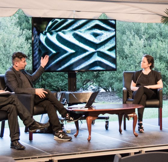 a small group of people having a conversation on a stage 